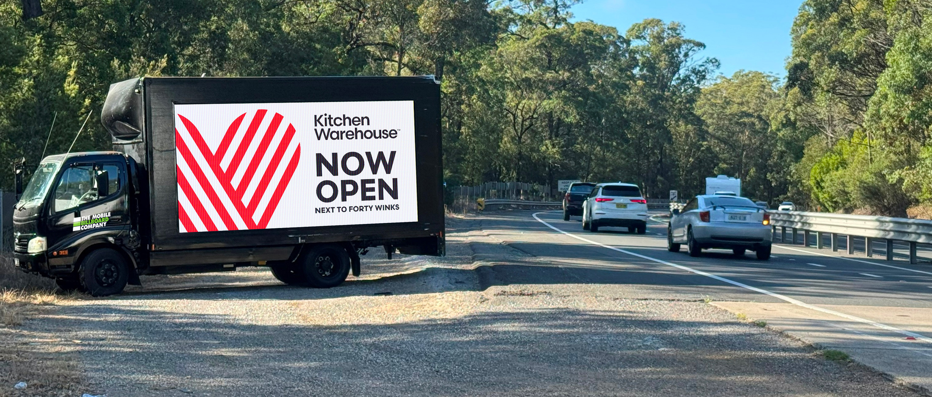 Kitchen Warehouse B Kitchen Warehouse mobile billboard on Sydney suburban road targeting local homeowners and families